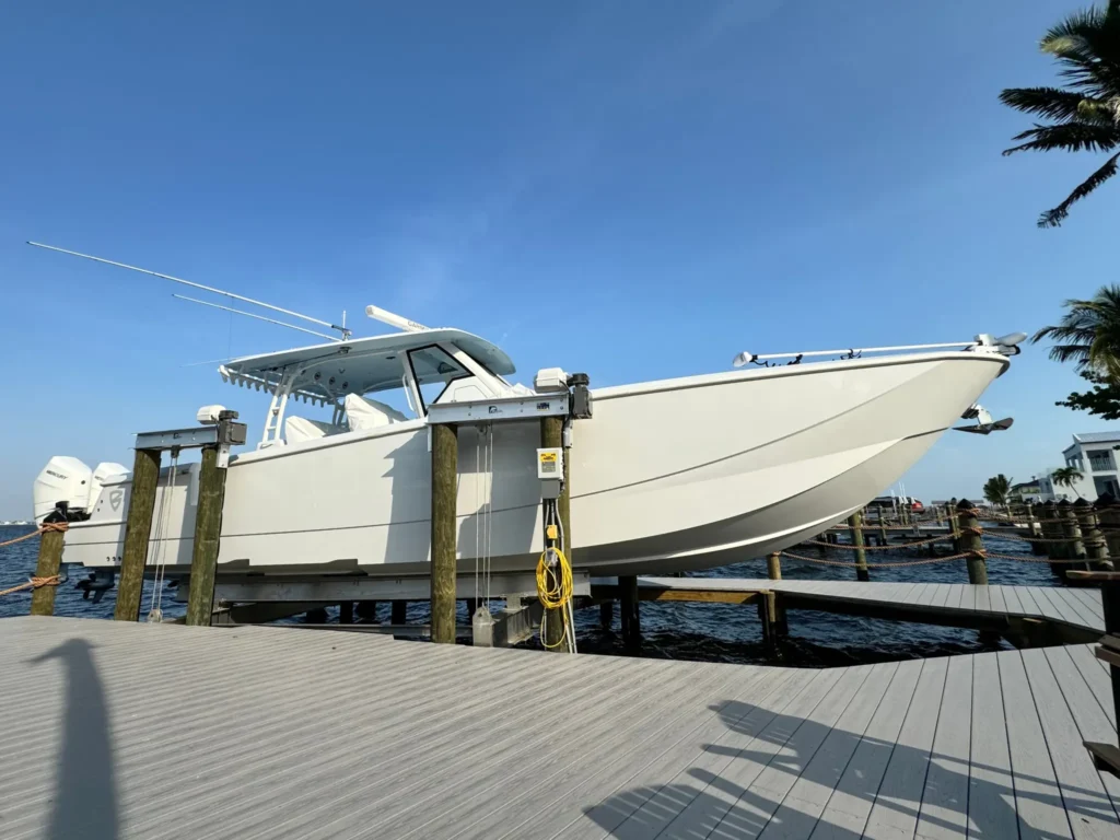 Brand new Cape Coral dock with 6,000 lift holding a beautiful two-motor boat. Happy customer ready to enjoy the SWFL waters.