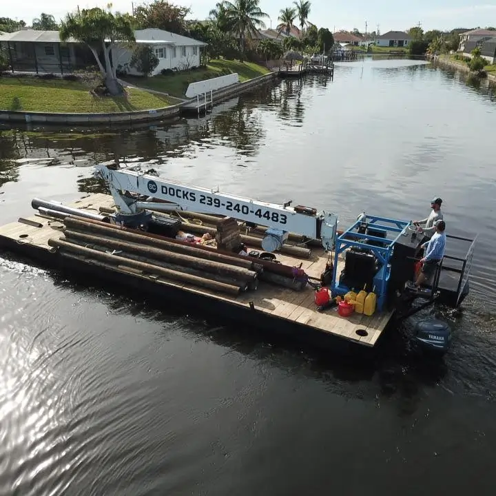 Submerge Consultant's barge on the water, ready to help Southwest Florida coastal homeowners with restoration services.