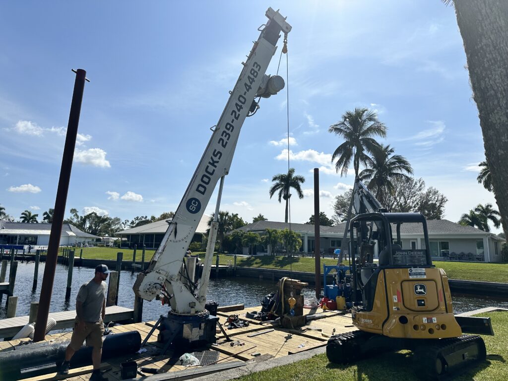 Submerged Consultants barge on work site with a skidsteer