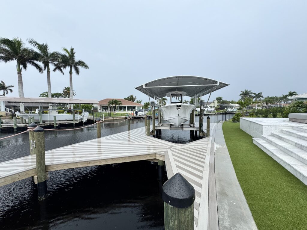 Custom boat dock 2 slip with a canopy over a boat lift and a wet slip/ mooring area
