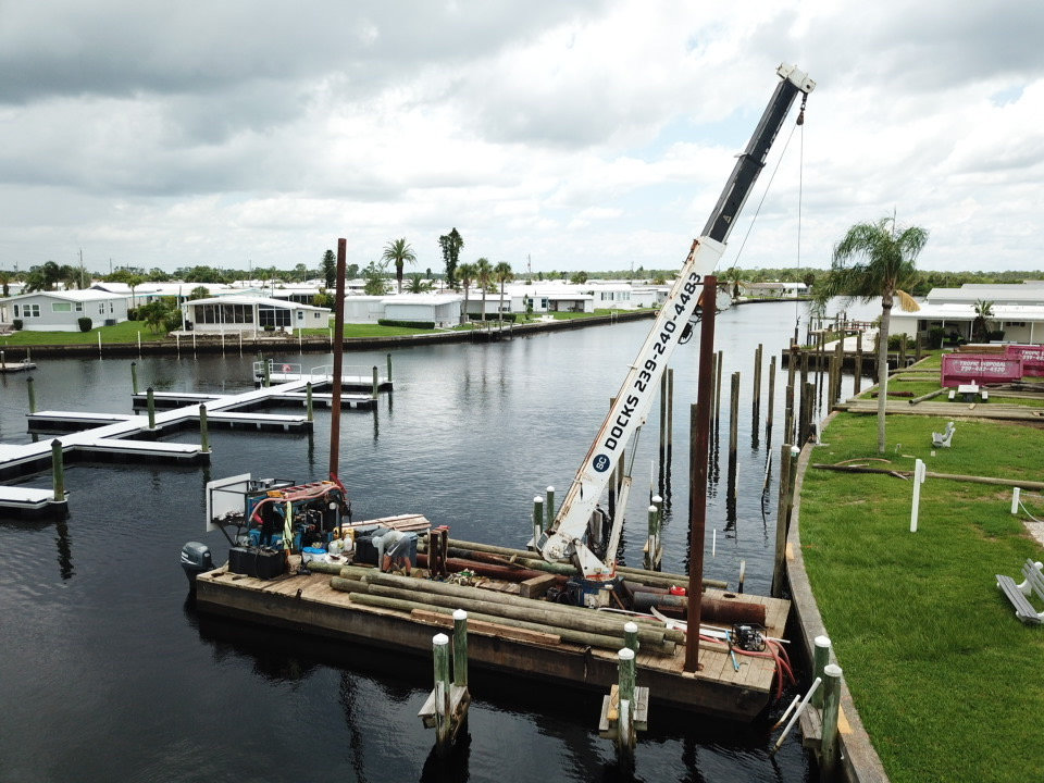 Barge working in Harbor Cove Marina to replace finger docks; dock repair in North Port fl